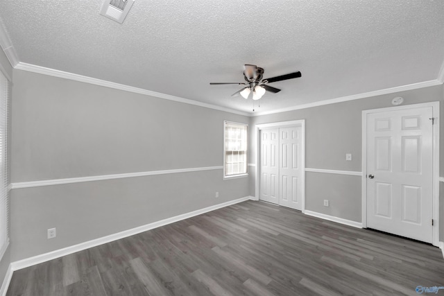 unfurnished bedroom featuring crown molding, dark hardwood / wood-style flooring, a closet, and a textured ceiling