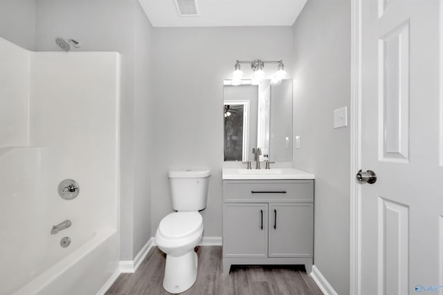 full bathroom with vanity, shower / tub combination, toilet, and wood-type flooring