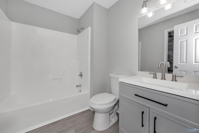 full bathroom with vanity, wood-type flooring, bathing tub / shower combination, and toilet