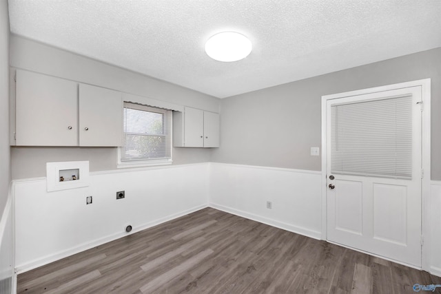 laundry room featuring dark hardwood / wood-style flooring, cabinets, washer hookup, and hookup for an electric dryer