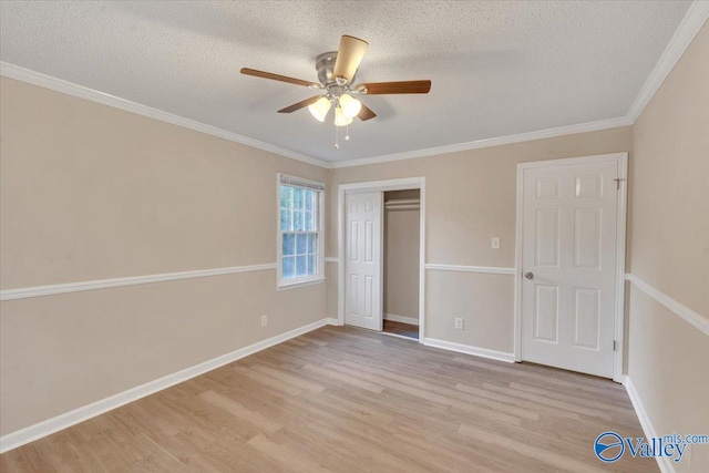 unfurnished bedroom featuring crown molding, a closet, light hardwood / wood-style floors, and a textured ceiling