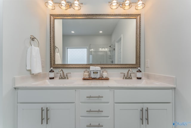 162 Saddle St, New Market, AL 35761 - bathroom featuring double vanity, a sink, a shower with shower door, and a chandelier