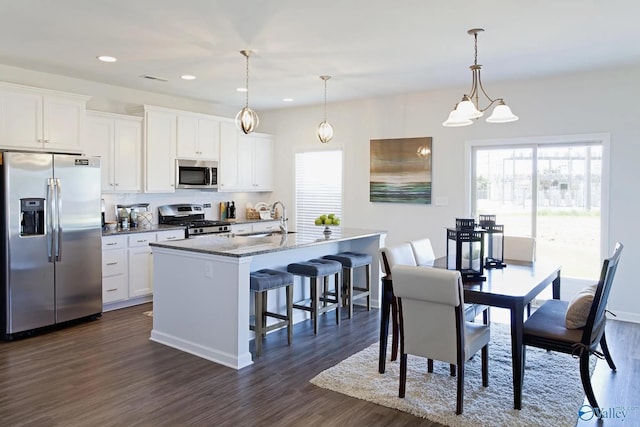 162 Saddle St, New Market, AL 35761 - kitchen with a wealth of natural light, stainless steel appliances, a kitchen breakfast bar, and a kitchen island with sink