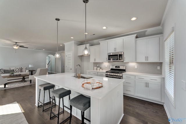 162 Saddle St, New Market, AL 35761 - kitchen with crown molding, backsplash, a sink, stainless steel appliances, and dark wood-type flooring
