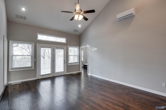 spare room featuring high vaulted ceiling, dark hardwood / wood-style floors, an AC wall unit, and ceiling fan