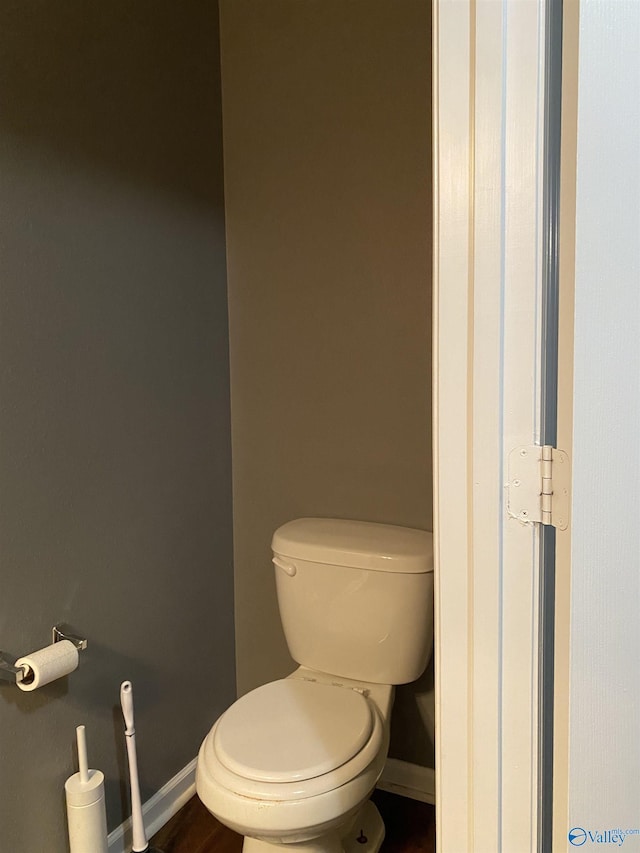 bathroom featuring toilet and baseboards