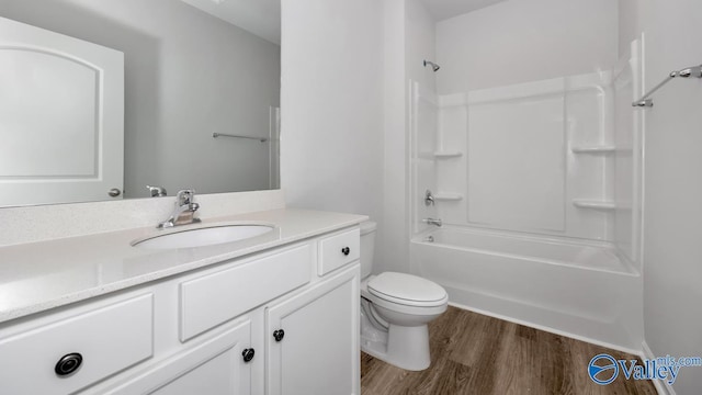 full bathroom with shower / bathing tub combination, hardwood / wood-style floors, vanity, and toilet