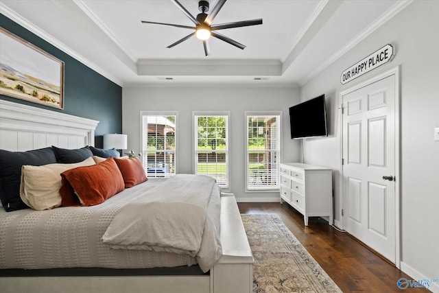 bedroom featuring crown molding, a tray ceiling, and dark hardwood / wood-style floors