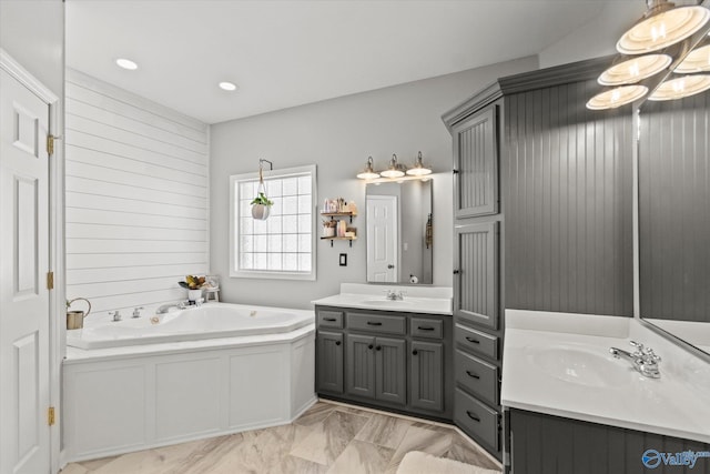 bathroom featuring vanity and a bath