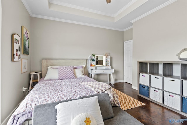 bedroom featuring crown molding, dark hardwood / wood-style floors, a raised ceiling, and ceiling fan