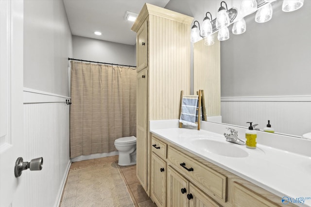 bathroom featuring vanity, tile patterned flooring, a shower with curtain, and toilet