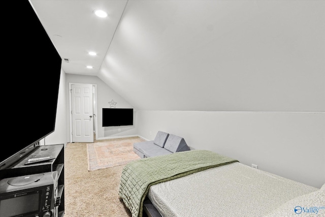 bedroom with vaulted ceiling and carpet flooring