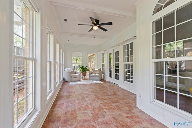 unfurnished sunroom with ceiling fan