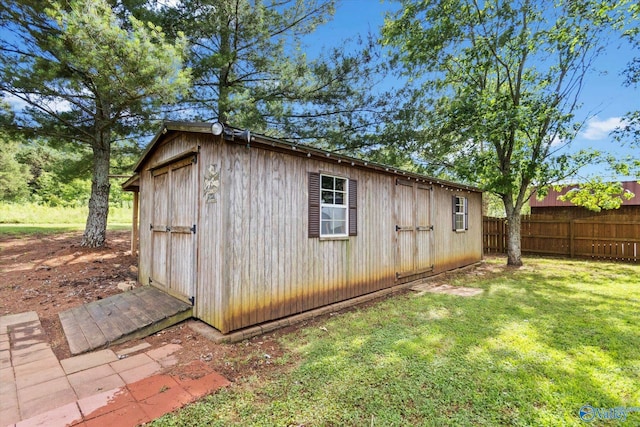 view of outbuilding featuring a yard