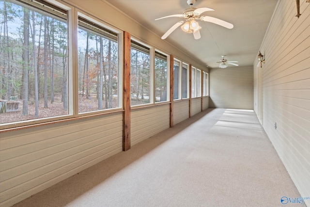 sunroom featuring ceiling fan