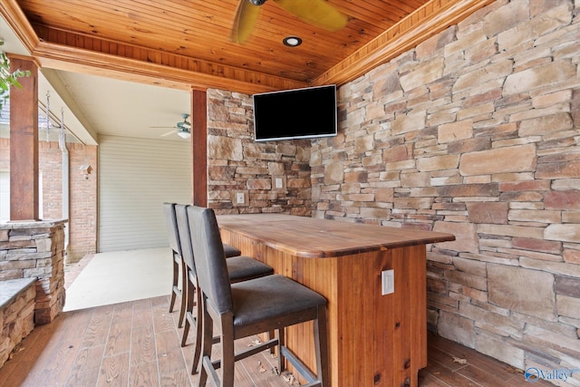 exterior space featuring wood-type flooring, wooden ceiling, and a ceiling fan