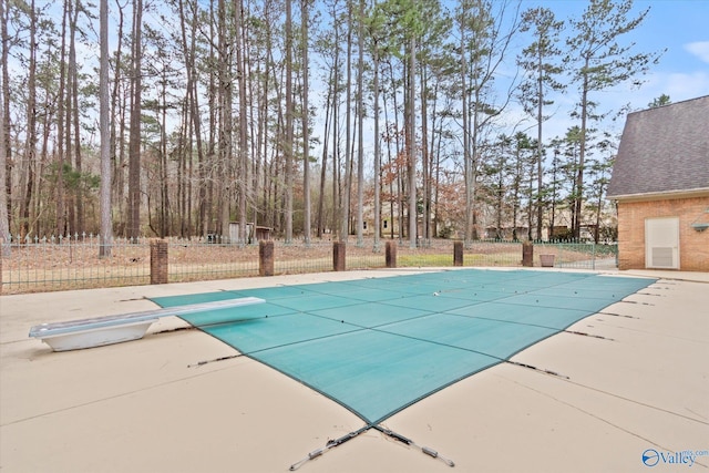 view of pool with a patio area, a covered pool, and fence