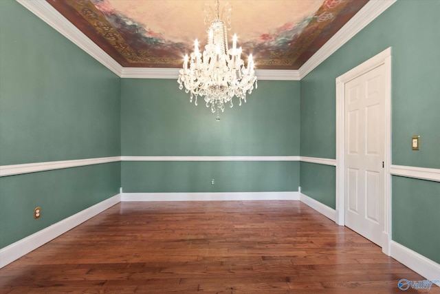 unfurnished room with a chandelier, baseboards, and wood finished floors