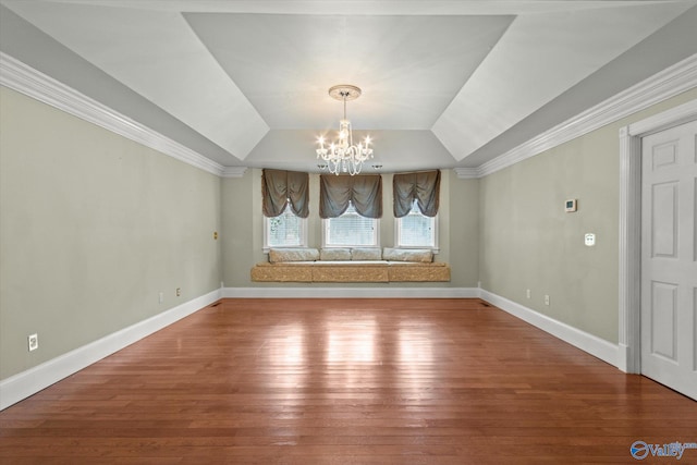 bonus room featuring baseboards, hardwood / wood-style floors, and an inviting chandelier