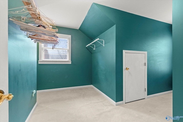 spacious closet featuring carpet floors and vaulted ceiling