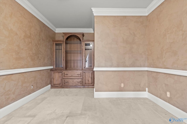 unfurnished room featuring light carpet, baseboards, and ornamental molding