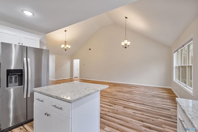 kitchen featuring white cabinetry, a chandelier, a center island, stainless steel fridge with ice dispenser, and light hardwood / wood-style flooring