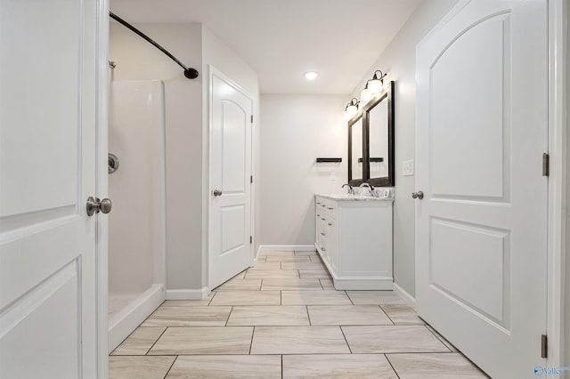 bathroom with a shower and vanity