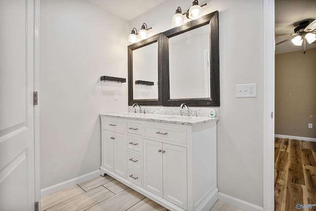 bathroom featuring vanity, hardwood / wood-style floors, and ceiling fan