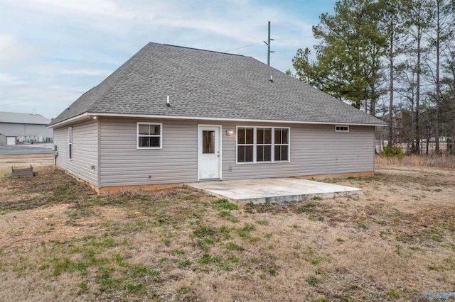 rear view of property featuring a lawn and a patio