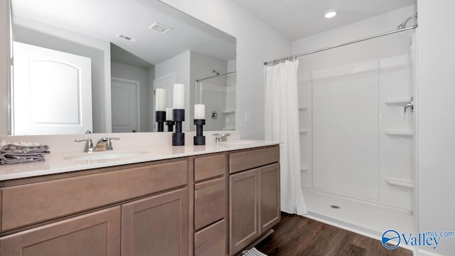 bathroom with wood-type flooring, vanity, and a shower with curtain