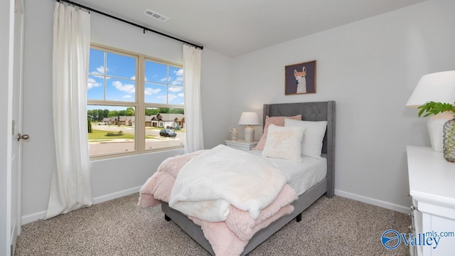 carpeted bedroom featuring multiple windows