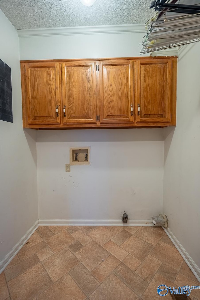 washroom featuring baseboards, cabinet space, washer hookup, and stone finish flooring