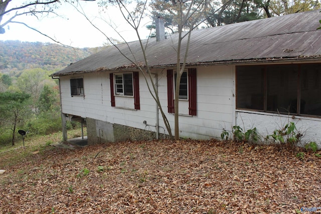 view of property exterior featuring a sunroom