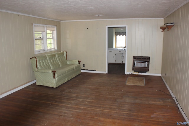 unfurnished room featuring ornamental molding, dark hardwood / wood-style flooring, heating unit, and wooden walls