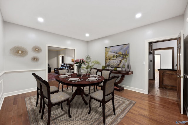 dining area with dark hardwood / wood-style flooring