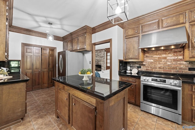 kitchen with ventilation hood, a center island, pendant lighting, appliances with stainless steel finishes, and tasteful backsplash