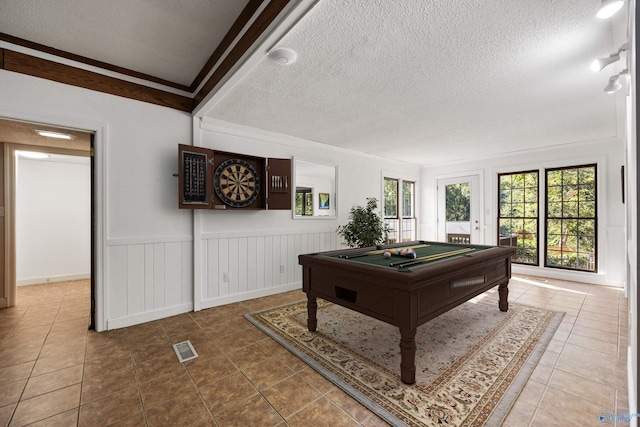 game room featuring crown molding, pool table, a textured ceiling, and tile patterned flooring