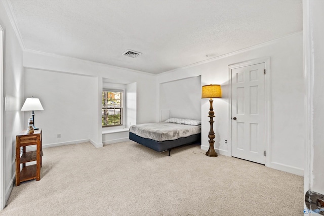 carpeted bedroom featuring ornamental molding and a textured ceiling