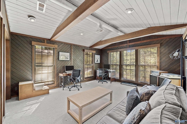 carpeted living room featuring lofted ceiling with beams and wood walls