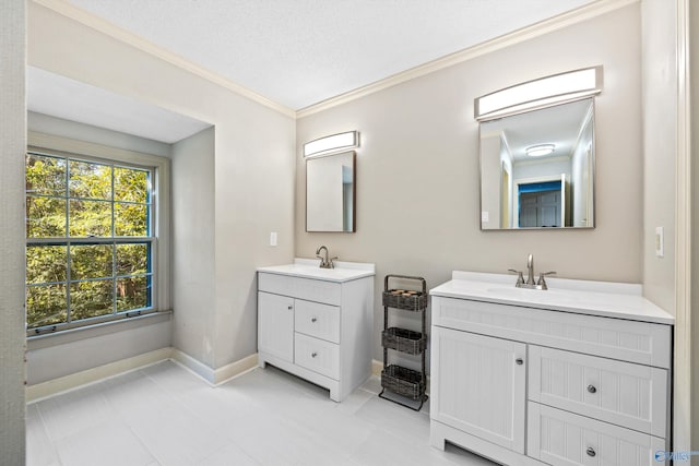 bathroom with vanity, ornamental molding, and a textured ceiling