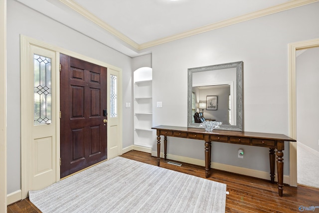 entryway with ornamental molding and wood-type flooring