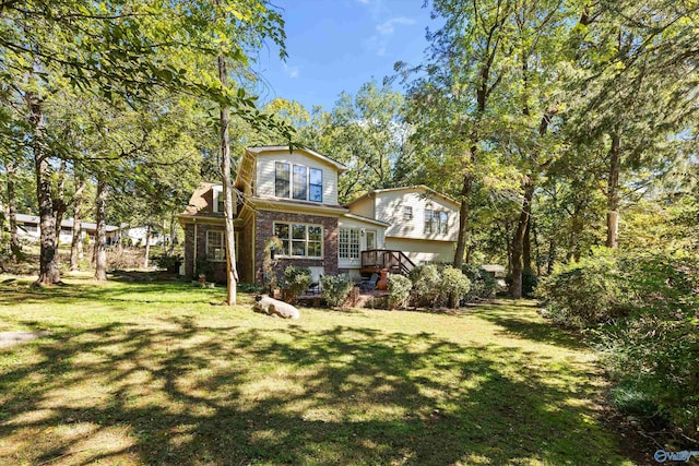 rear view of property featuring a yard and a deck