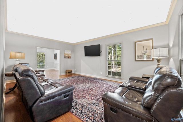 living room with crown molding, hardwood / wood-style flooring, and plenty of natural light