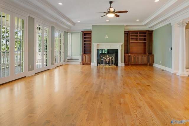 unfurnished living room featuring ceiling fan, light hardwood / wood-style flooring, decorative columns, and ornamental molding