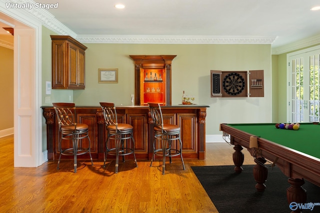 rec room featuring bar, billiards, light hardwood / wood-style flooring, and crown molding