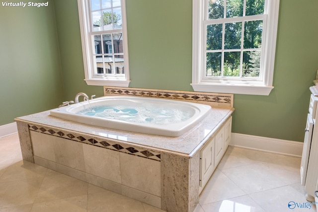 bathroom featuring tiled bath and tile patterned flooring