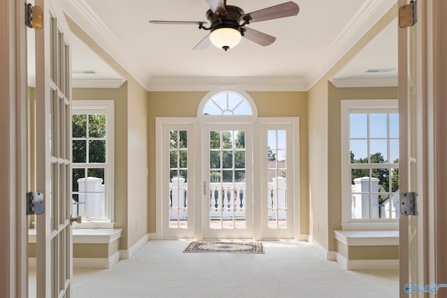 entryway featuring ceiling fan, crown molding, french doors, and light carpet