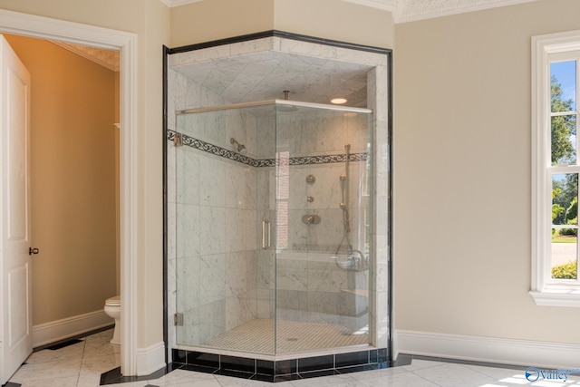 bathroom featuring tile patterned flooring, an enclosed shower, toilet, and crown molding