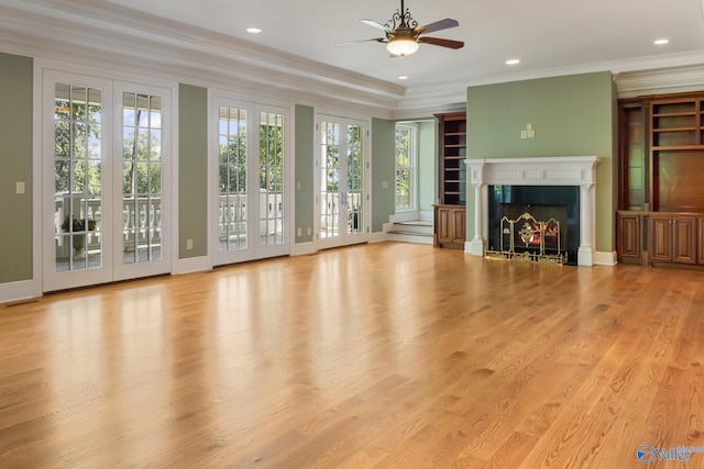 unfurnished living room with light hardwood / wood-style flooring, ceiling fan, crown molding, and french doors