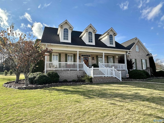 cape cod-style house featuring a front yard and a porch